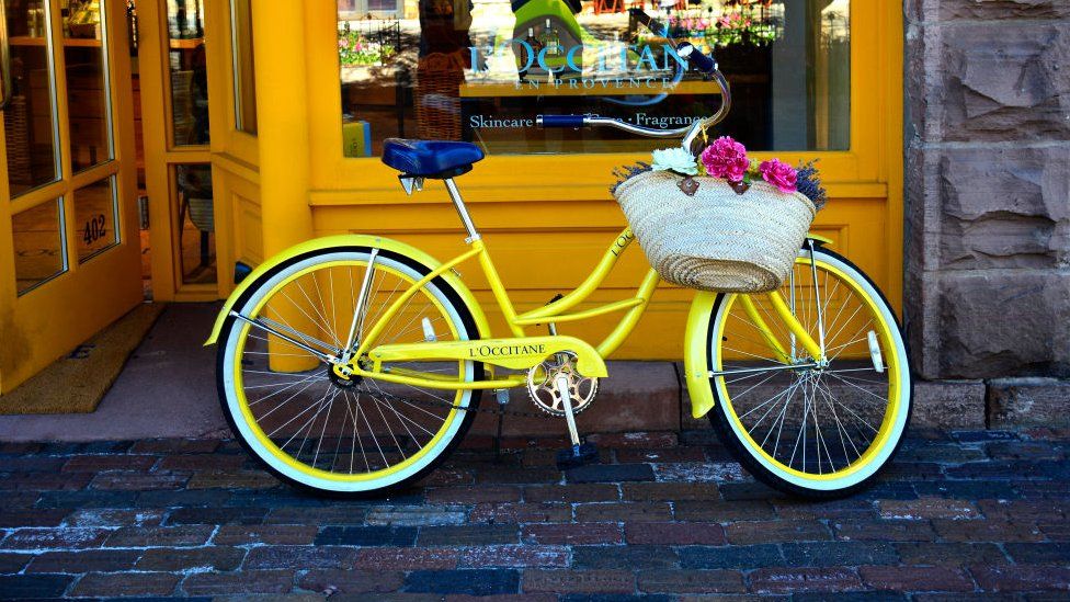 A yellow bicycle promotes the brand in front of the L'Occitane en Provence shop in Aspen, Colorado