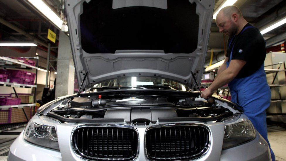 A man checks a car on the BMW 3-series production line at the BMW factory on March 15, 2010 in Munich, Germany.