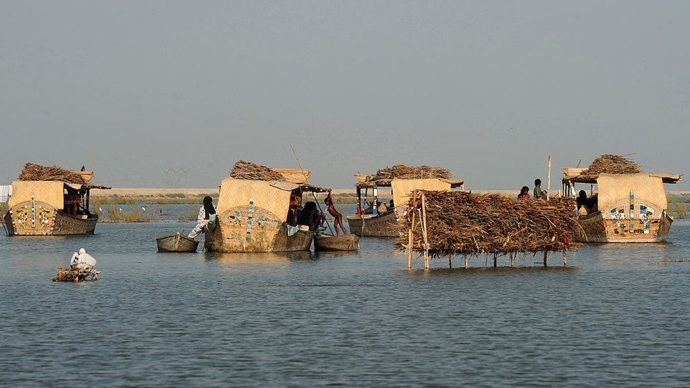 Families go about their daily business on their floating boathouses on Manchar lake, a 223 square kilometre natural water reservoir in southern Pakistan on September 9, 2016.