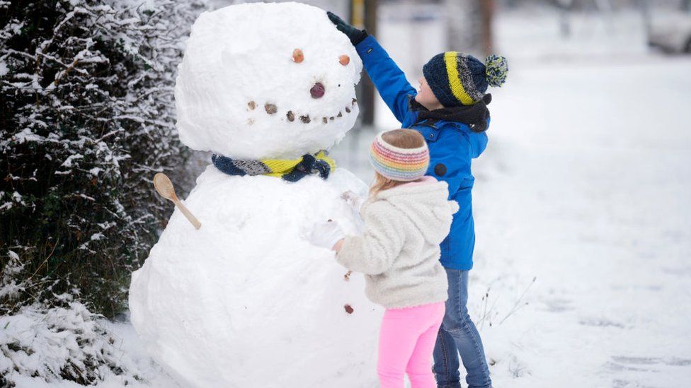 Children build a snowman after the first significant snow fall in Cheshire this Winter on December 10, 2022 in Northwich, United Kingdom
