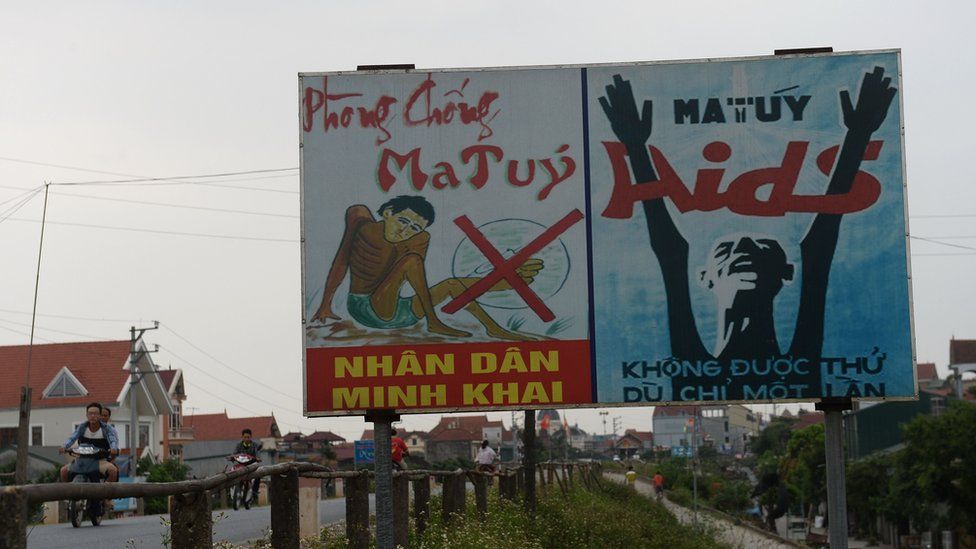 Billboards warning about drug addiction, beside a road outside Hanoi. 18 May 2016.