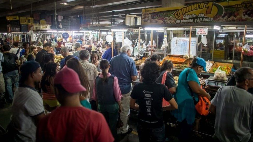 Venezuelans shop in a municipal market in Caracas on 18 August 2018.
