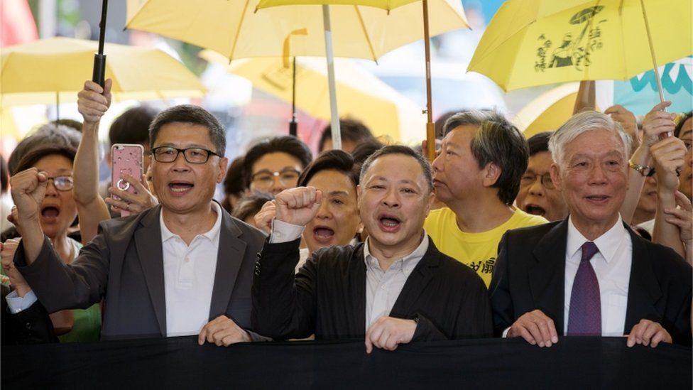 Activists Chan Kin-man, Benny Tai, and Chu Yiu-ming outside court in Hong Kong ahead of their sentencing, April 2019