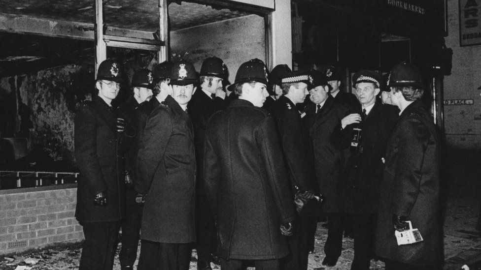 Police officers after the riots