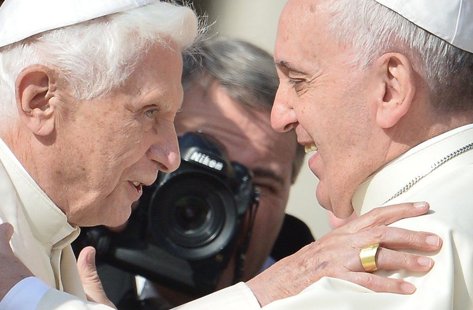 Pope emeritus Benedict XVI is welcomed to a mass by Pope Francis