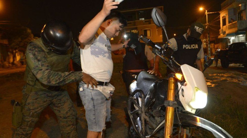 A soldier frisks a local in Cerro Las Cabras, a canton located in the province of Guayas, Ecuador, on April 29, 2022