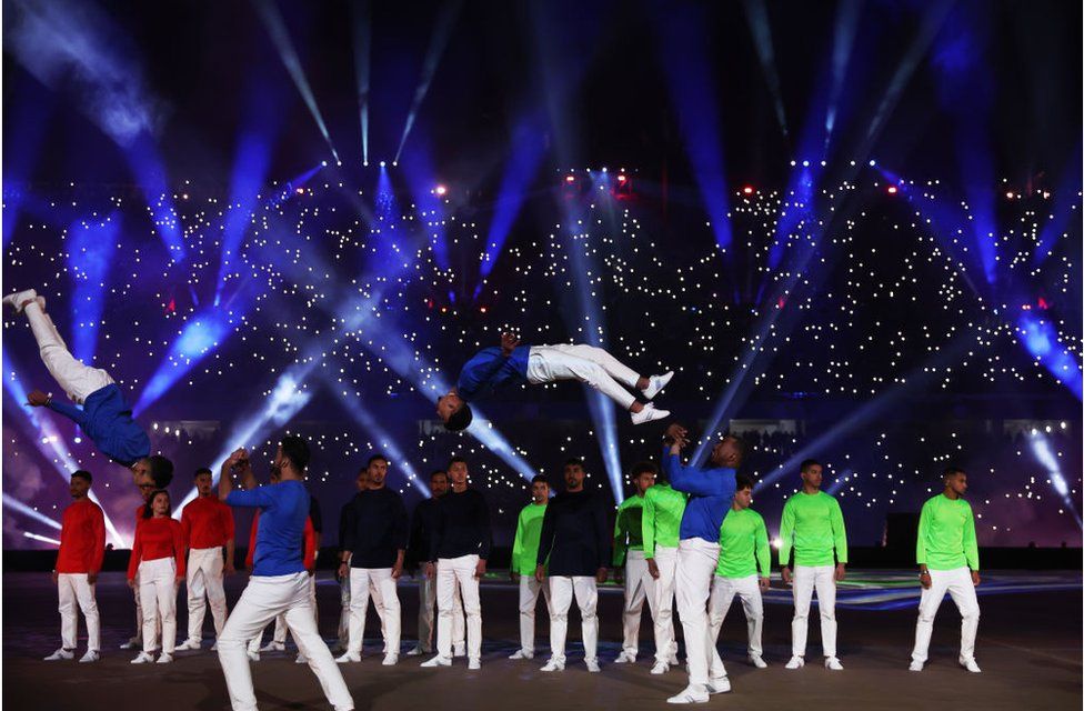 Dancers doing what looks like acrobatics on stage.