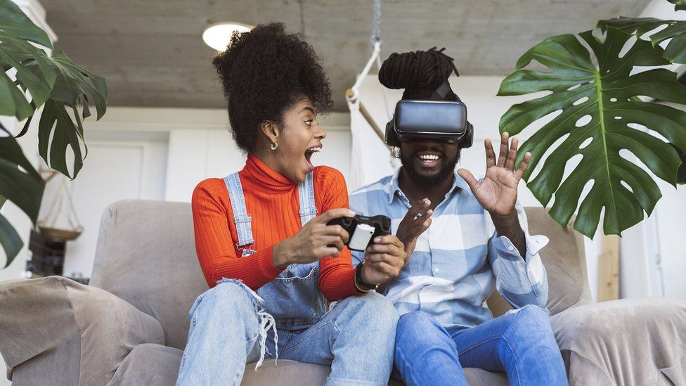 Woman and man gaming with VR headset