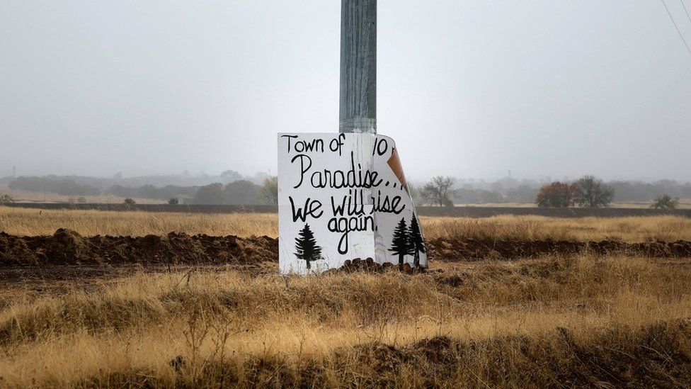 A handwritten sign is seen on a telephone pole on the road to Paradise, California, U.S. November 21, 2018