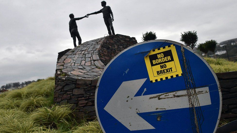 A No Border No Brexit sticker close to the Hands Across the Divide peace statue
