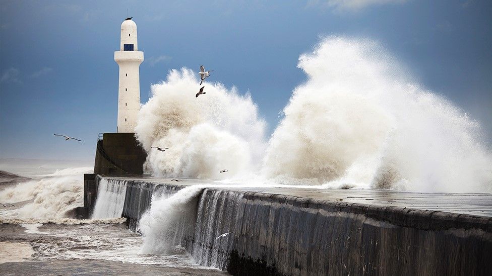 sea crashing around a lighthouse