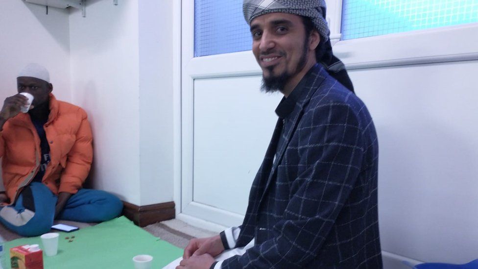 man in traditional Muslim clothing kneeling