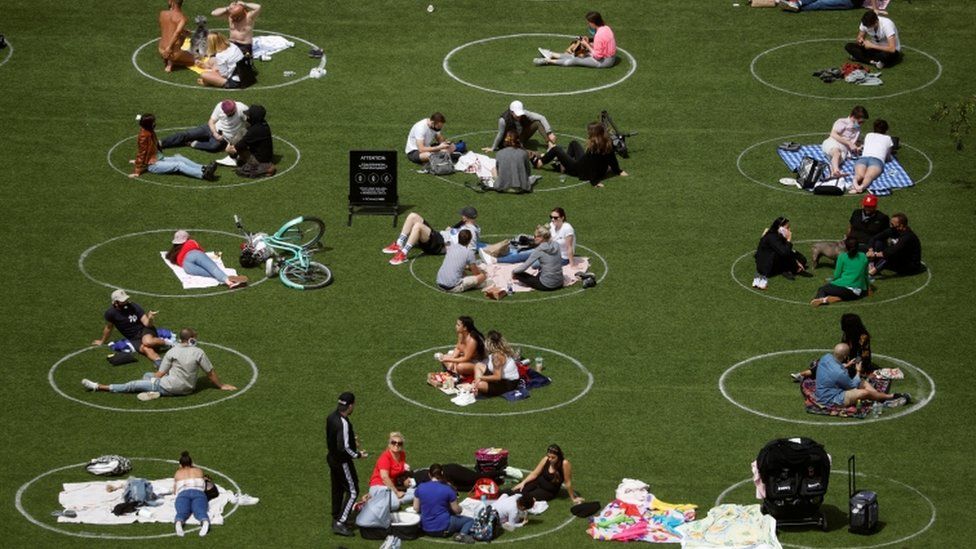 People in Domino Park are seen in circles painted as guidelines for social distancing during the outbreak of the coronavirus disease (COVID-19) in Brooklyn, New York City, U.S., May 24, 2020