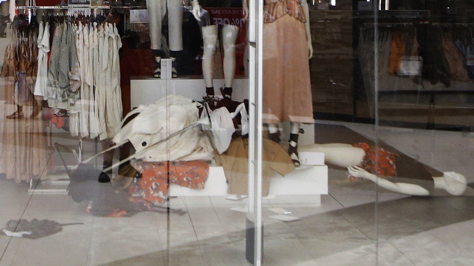 Clothes racks and mannequins lie on the floor of an H&M store after it was shut down by activists from South Africa's EFF party