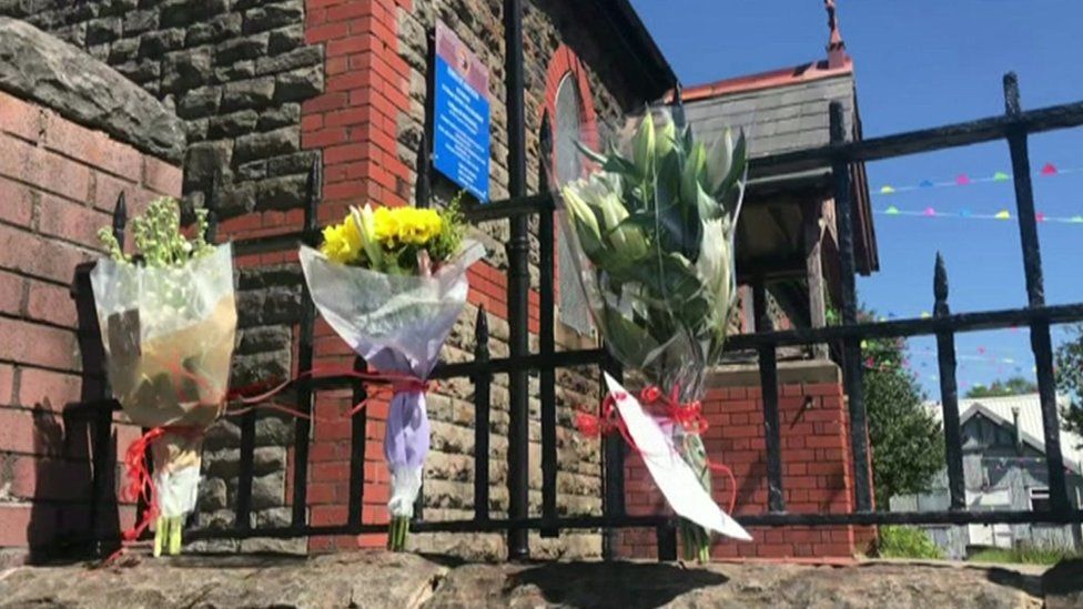 Floral tributes on church railings