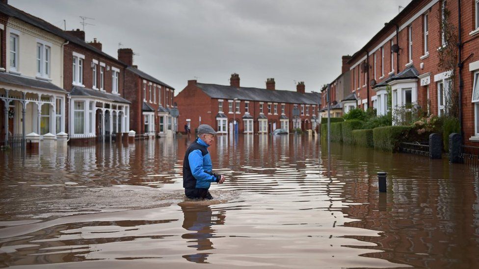 Man in flood water in Carlisle