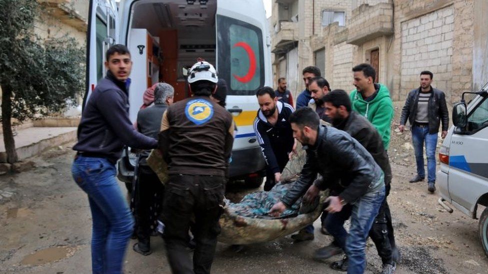 Syrian Civil Defence carries a wounded woman following a strike in the town of Khan Sheikhoun in the southern countryside of the rebel-held Idlib province, on 15 February 2019