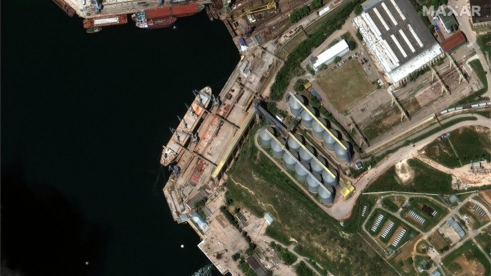 A satellite image shows a bulk carrier ship loading grain at the port of Sevastopol