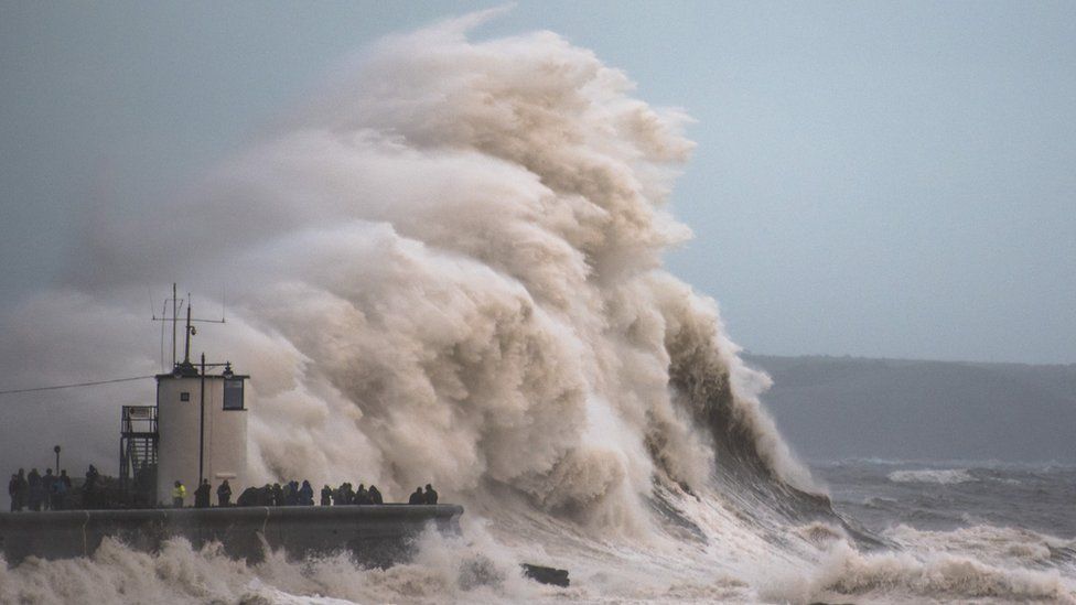 Waves crash over the cost in Porthcawl, Wales, as Storm Brian hits the UK