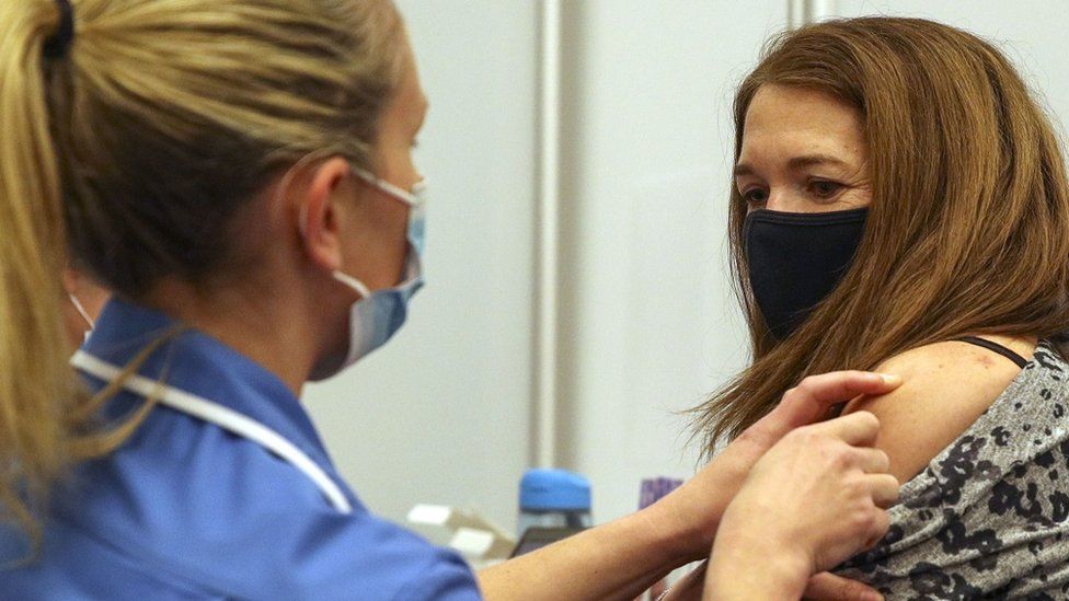 File image of a nurse administering the Moderna vaccine to a patient in Reading, in April