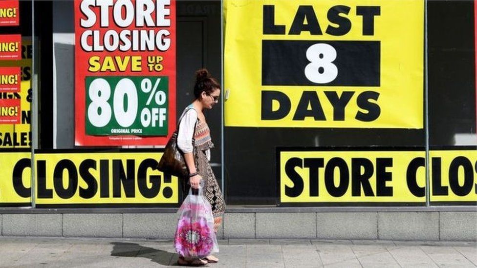 High street with closing down sale signs