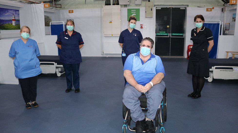 Arfon Hardy (centre) with hospital staff