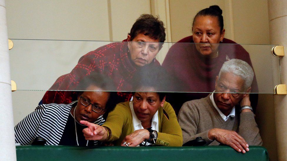 Audience members watch Mr Michel speak in parliament