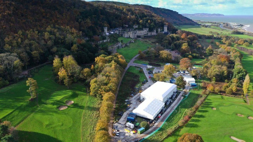 An aerial shot of Gwrych castle with a large white tent in the foreground