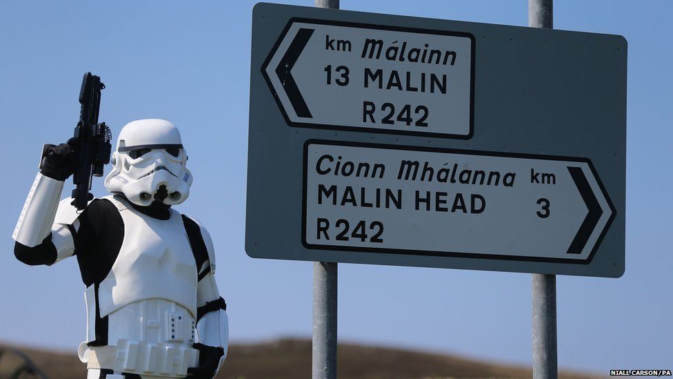 Star Wars fan John Joe McGettigan in stormtrooper costume beside a road sign near Malin Head