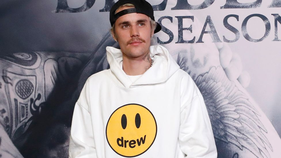 Justin Bieber poses in his own branded clothing range at the premiere for the documentary television series Justin Bieber: Seasons
