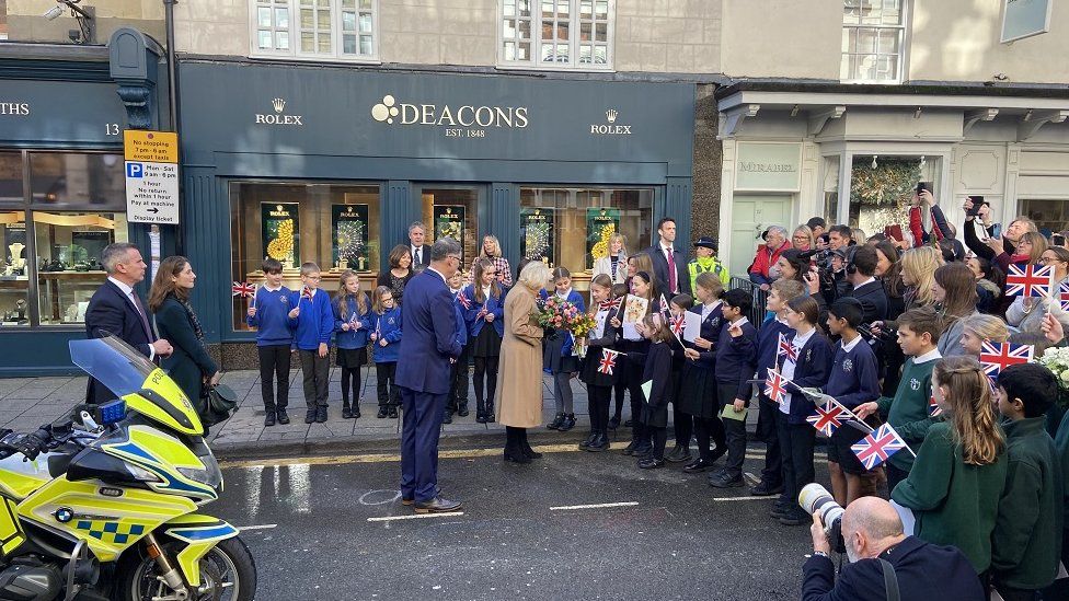 Local school children outside the jewellers to meet the Queen