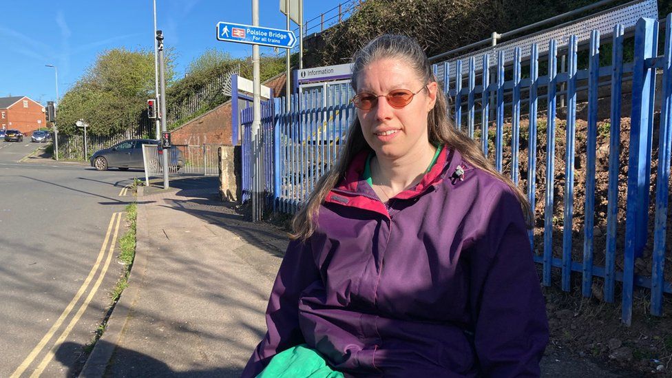 Woman by a train station