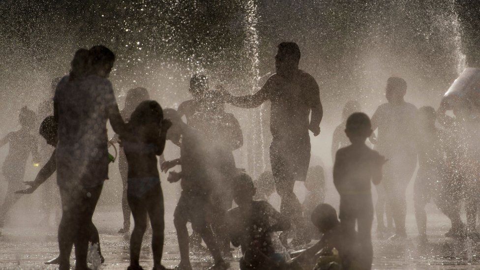 People cool off in a fountain in Madrid.