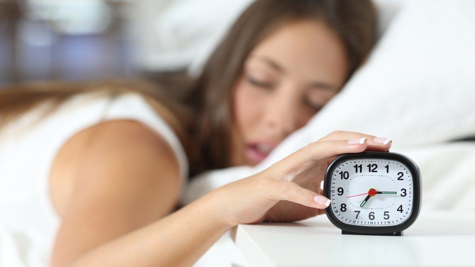 sleeping girl and alarm clock