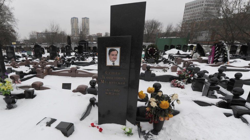 The snow clad grave of Russian lawyer Sergei Magnitsky with his portrait on the tomb in Moscow in 2012