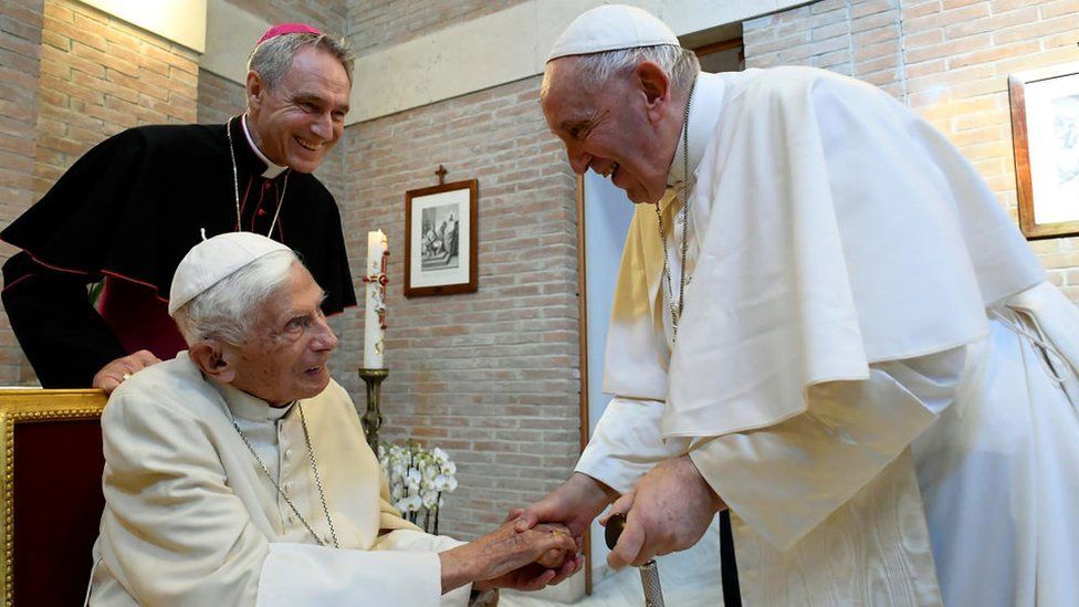 Pope Francis greets Pope Emeritus Benedict XVI during a meeting with newly named Cardinals at the Vatican's Mater Ecclesiae Monastery on August 27, 2022 in Vatican City, Vatican. Pope Francis on August 27, 2022 presided a consistory for the creation of 20 new Cardinals, 16 of whom are under the age of 80 and therefore Cardinal-electors in an eventual conclave, plus four who have already reached the age of 80 or will reach it before receiving the red biretta.