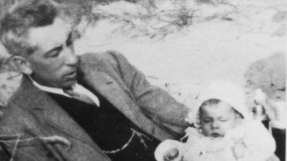 Joyce Currie, 6 months old, with her father on Fairbourne beach, 1925