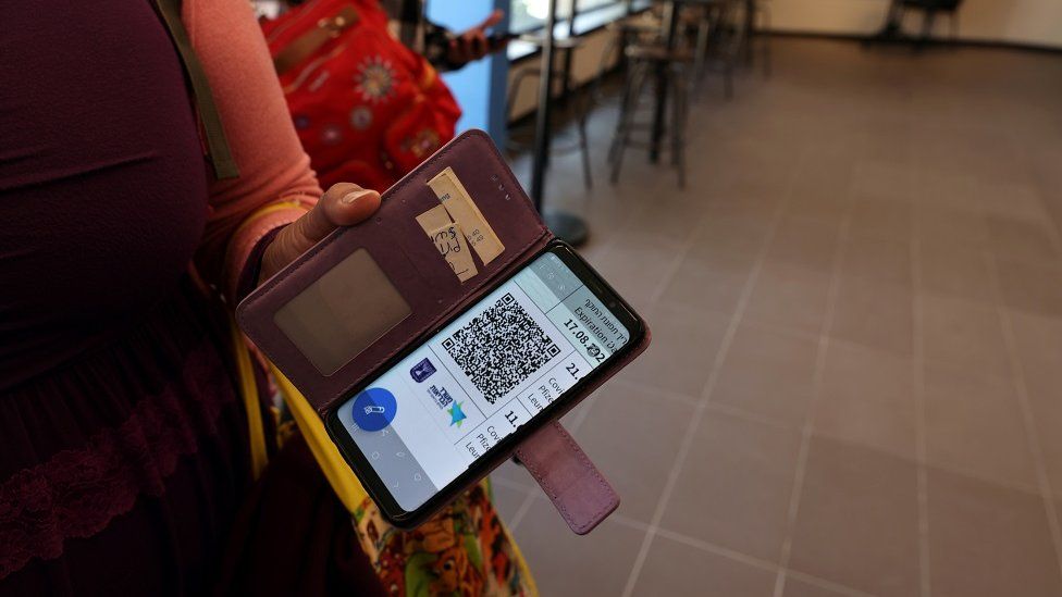 A woman shows her COVID vaccination status on her mobile phone at a gym where a "Green Badge" is required to enter, as Israel reopens swathes of its economy, continuing to lift restrictions of a national lockdown to fight the coronavirus disease (COVID-19), at Gordon Gym and Pool in Tel Aviv, Israel