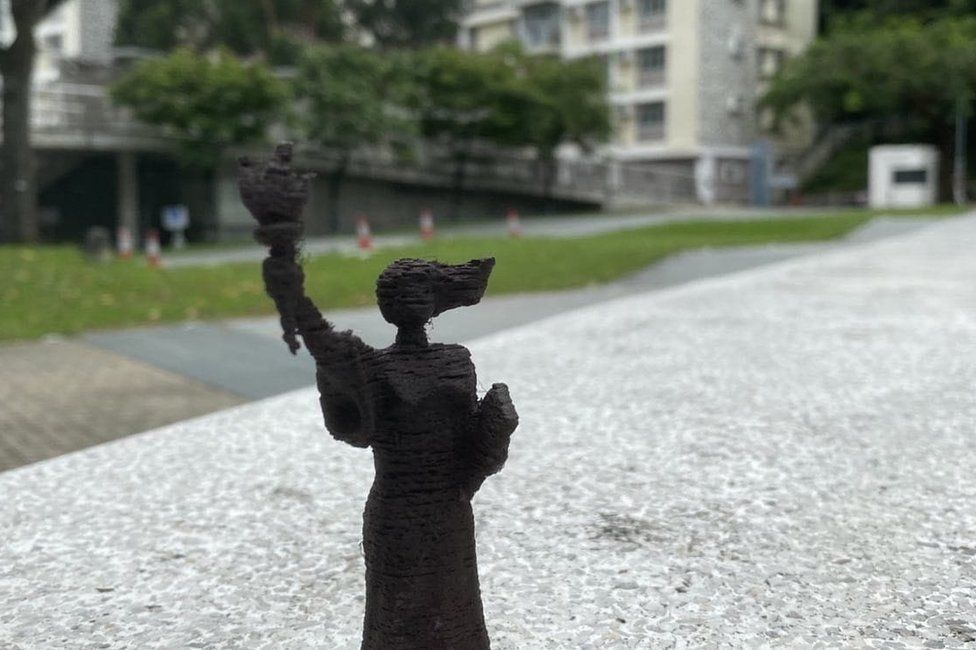 A figurine in the same location on campus where the statue once stood