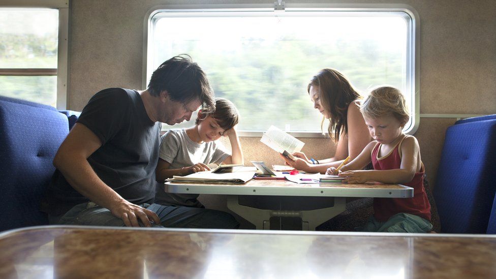 Family sat at a train table