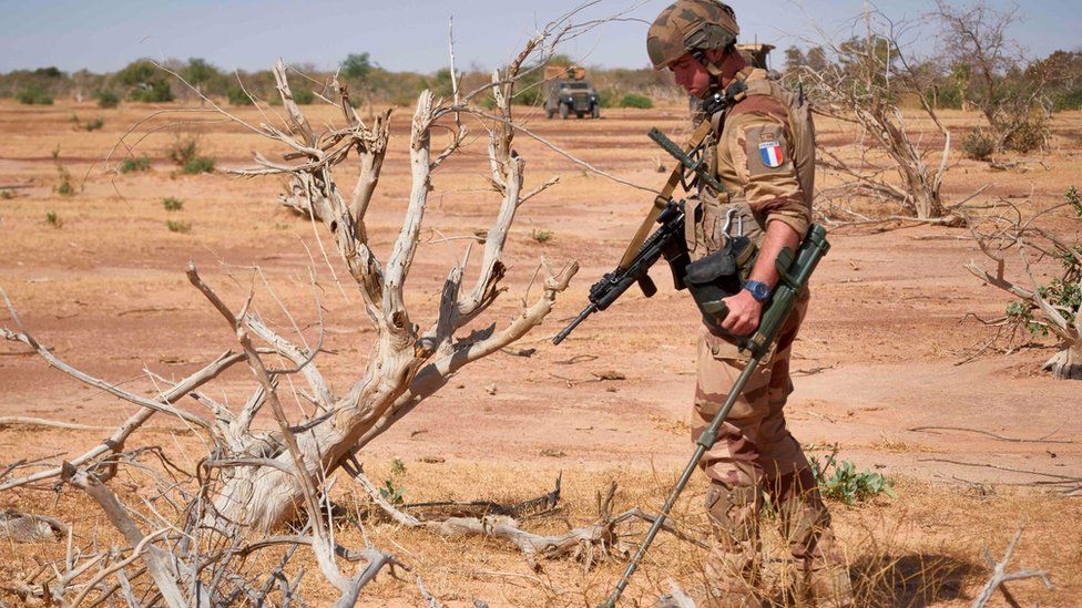 A French soldier holds a detector while searching for the presence of Improvised Explosive Devices in Burkina Faso