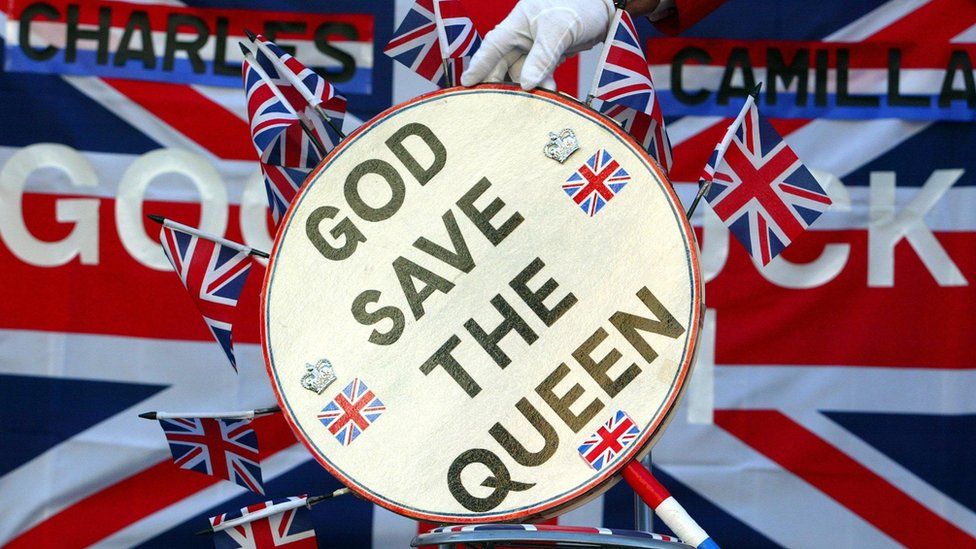 John Bull holds sign saying God Save the Queen