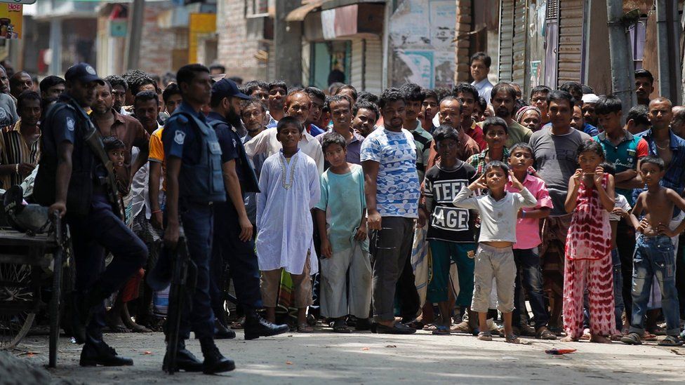 Bangladeshis gather near a shooting scene in Narayanganj, outskirts of Dhaka, Saturday, Aug. 27, 2016.