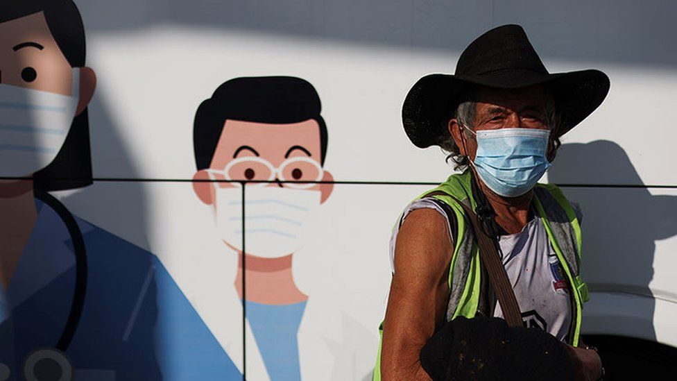 A man waits outside a mobile vaccination centre in Santiago, Chile