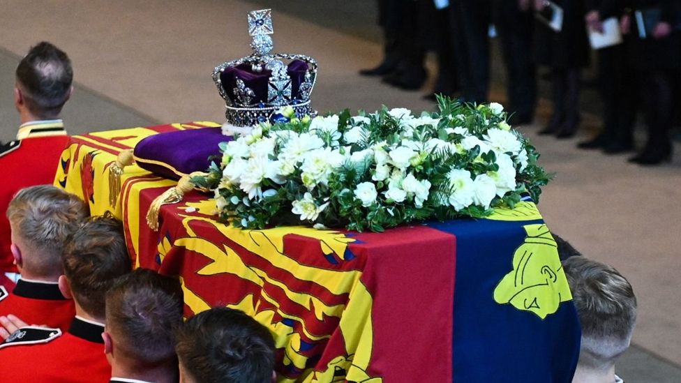 Pallbearers from The Queen's Company, 1st Battalion Grenadier Guards carry the coffin of Queen Elizabeth II into Westminster Hall at the Palace of Westminster in London on 14 September 2022