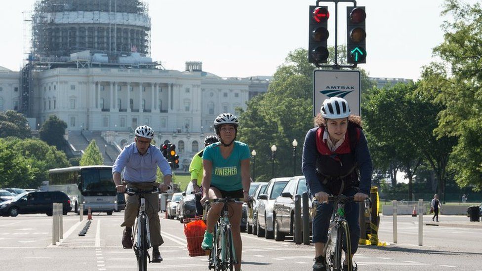 People ride bicycles past the US Capitol in Washington, DC, on May 24, 2016.