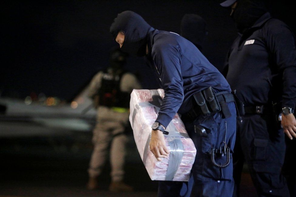 A police officer carries a package containing cocaine seized during an operation in the Caribbean, at the air base of the Ministry of Security in Alajuela, Costa Rica, 15 February 2020