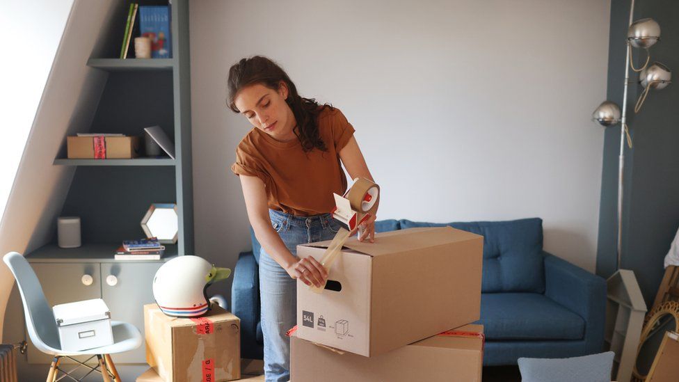 Woman packing up possessions
