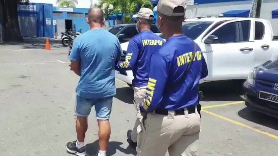 A man being led away by police