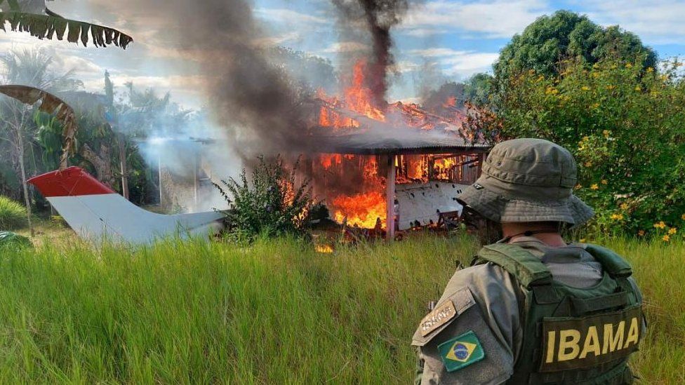 A handout photo made available by the Brazilian Institute of Environment (Ibama) of a soldier observing the destruction of areas of miners in the native territory of Yanomami, in the Amazon rainforest, during an operative for the expulsion of the thousands of illegal miners that operate in the zone in Roraima, Brazil, 08 February 2023.